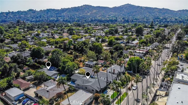 an aerial view of multiple houses with yard