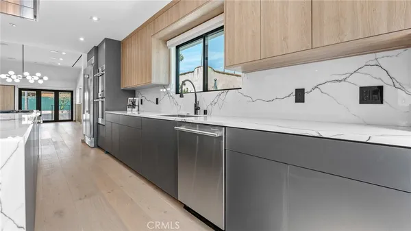 a kitchen with stainless steel appliances granite countertop a sink a stove and cabinets