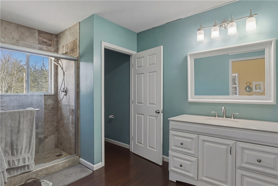 10684 Bear Run Road Corning, NY 14830 - Photo 28 of 32 Master Bathroom with a stall shower, large vanity and laminate flooring