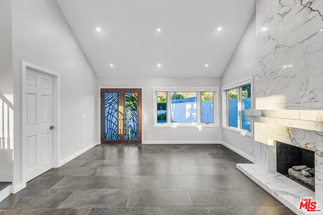 a kitchen with granite countertop white cabinets and white appliances