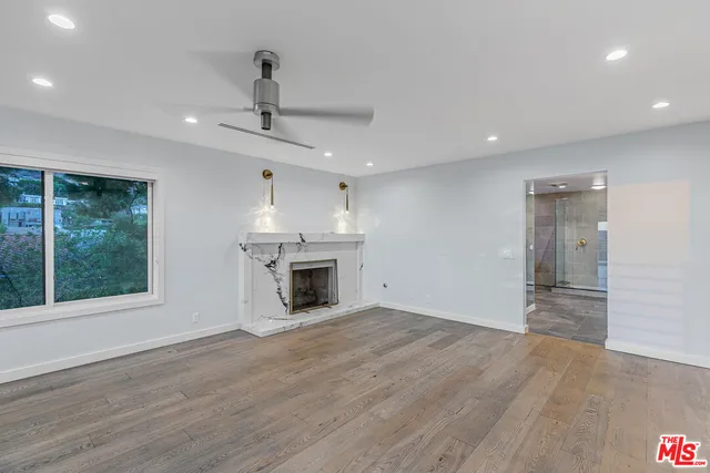 a view of a backyard with wooden fence and plants