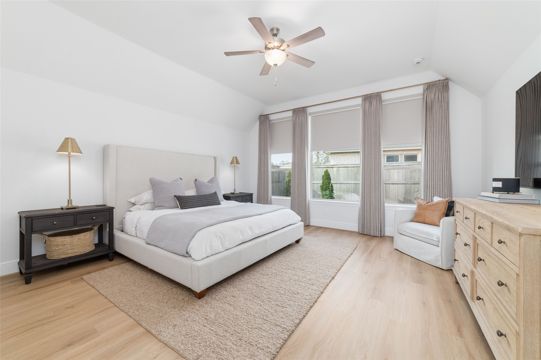 15208 Tree Swallow Court Magnolia, TX 77354 - Photo 16 of 50 a bedroom with a large bed and a chandelier fan