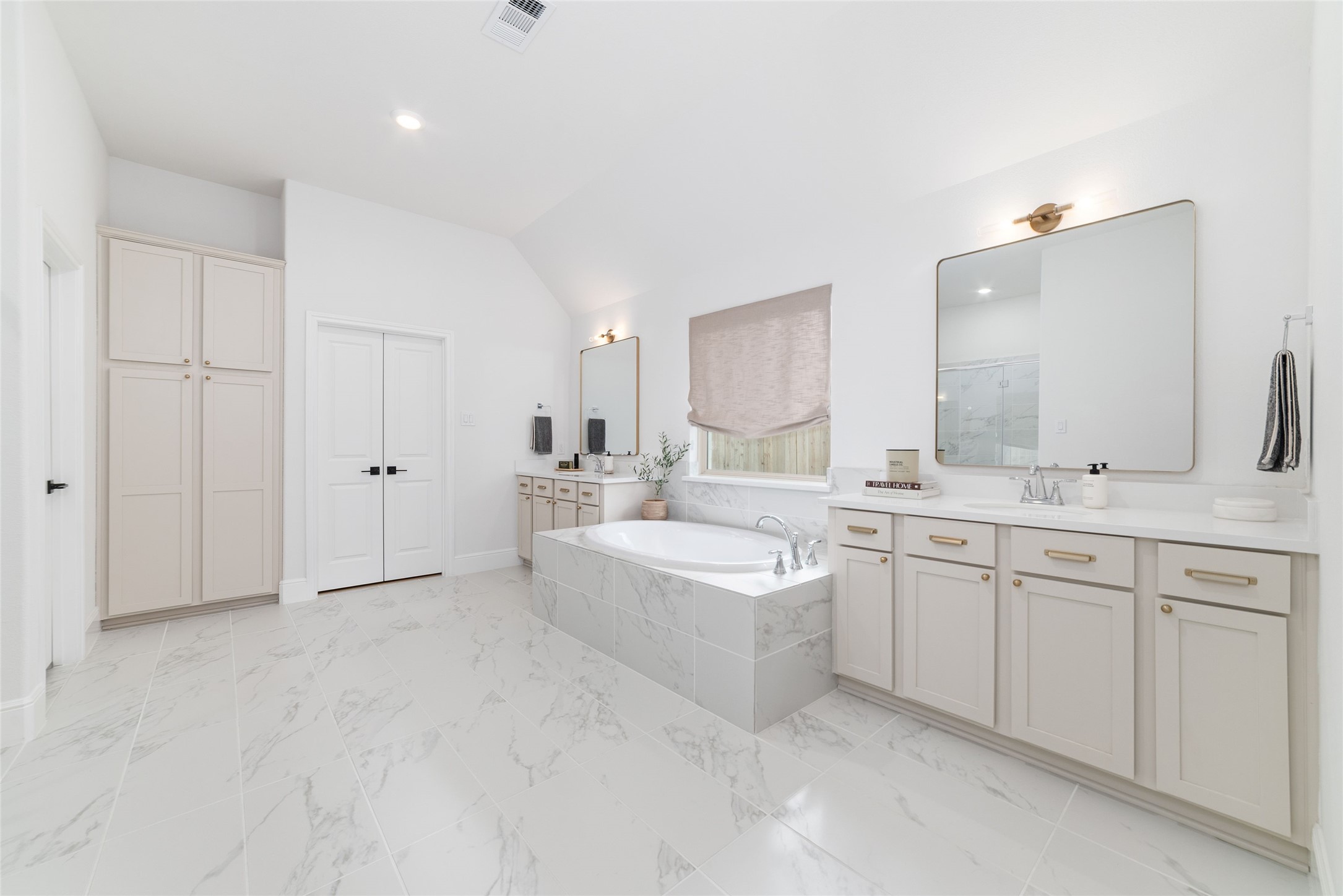 15208 Tree Swallow Court Magnolia, TX 77354 - Photo 18 of 50 a large bathroom with a double vanity sink a mirror and a bathtub