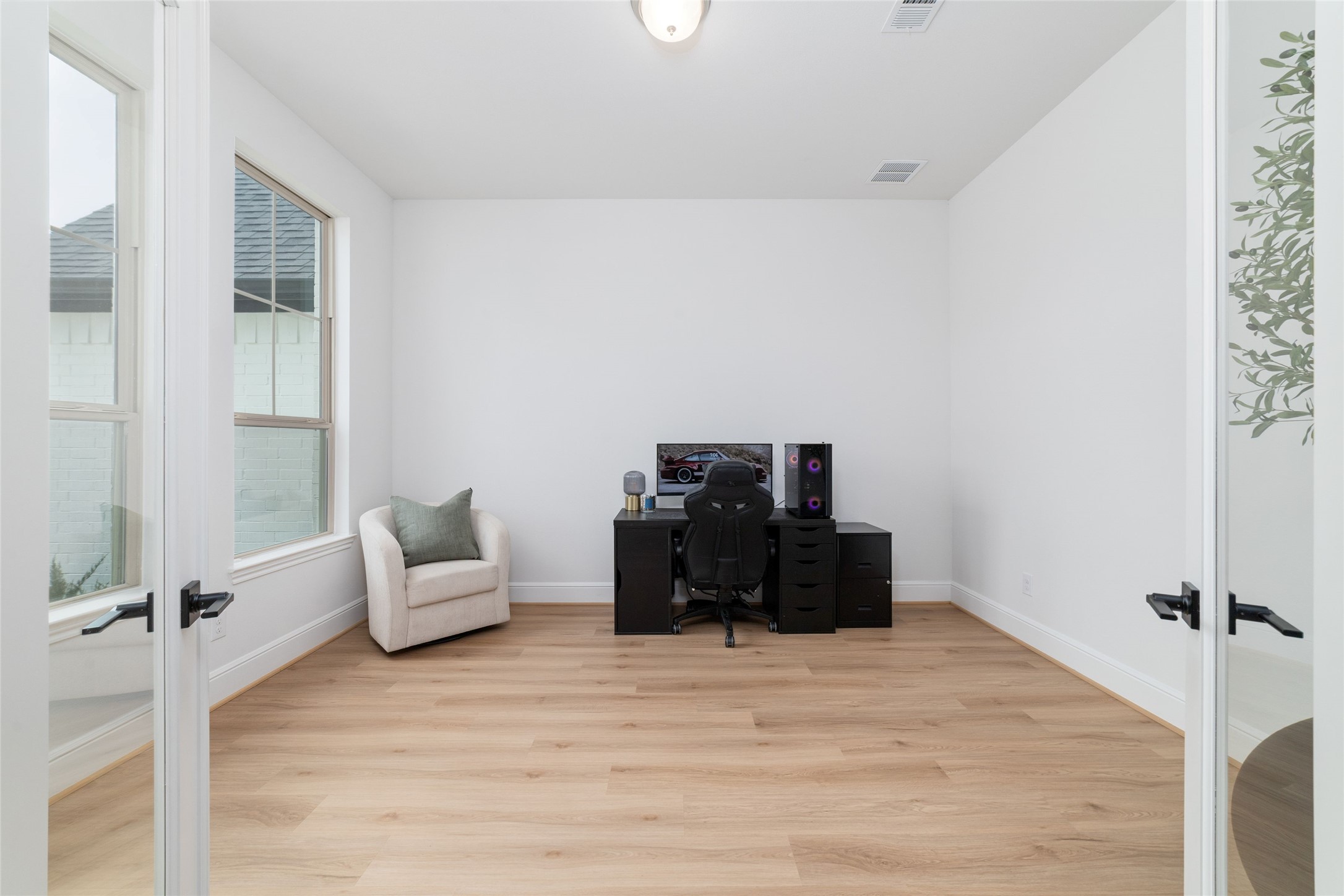 15208 Tree Swallow Court Magnolia, TX 77354 - Photo 20 of 50 a bed room with furniture and a wooden floor