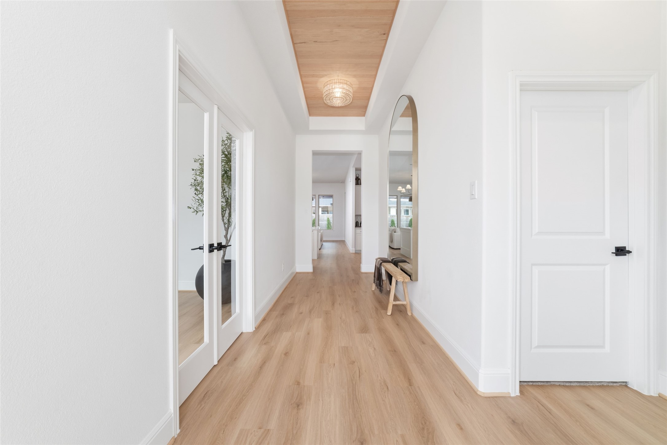 15208 Tree Swallow Court Magnolia, TX 77354 - Photo 4 of 50 a view of a hallway with wooden floor and a bathroom
