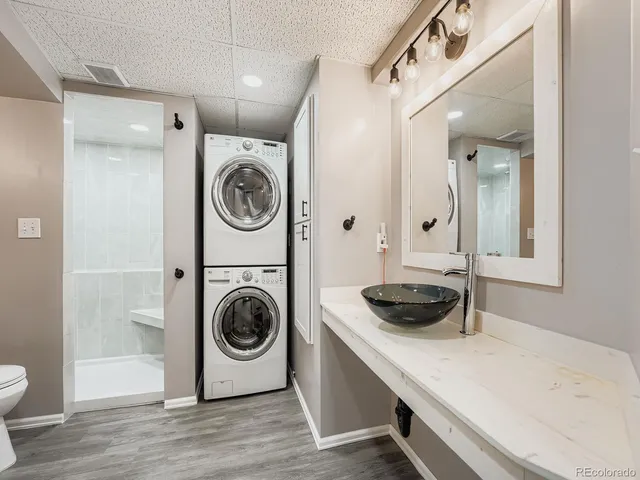 a utility room with sink dryer and washer