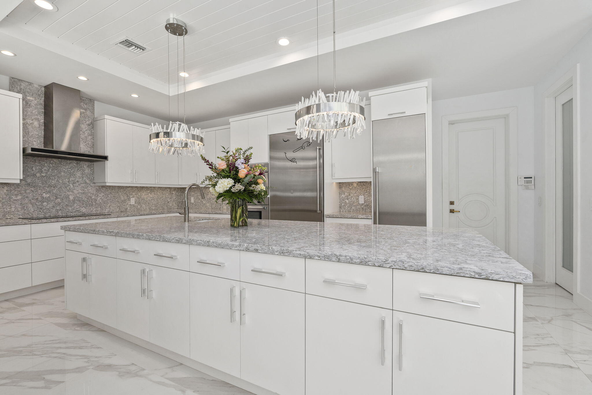 742 Marble Court Boca Raton, FL 33432 - Photo 19 of 95 a kitchen with kitchen island granite countertop stainless steel appliances sink and cabinets