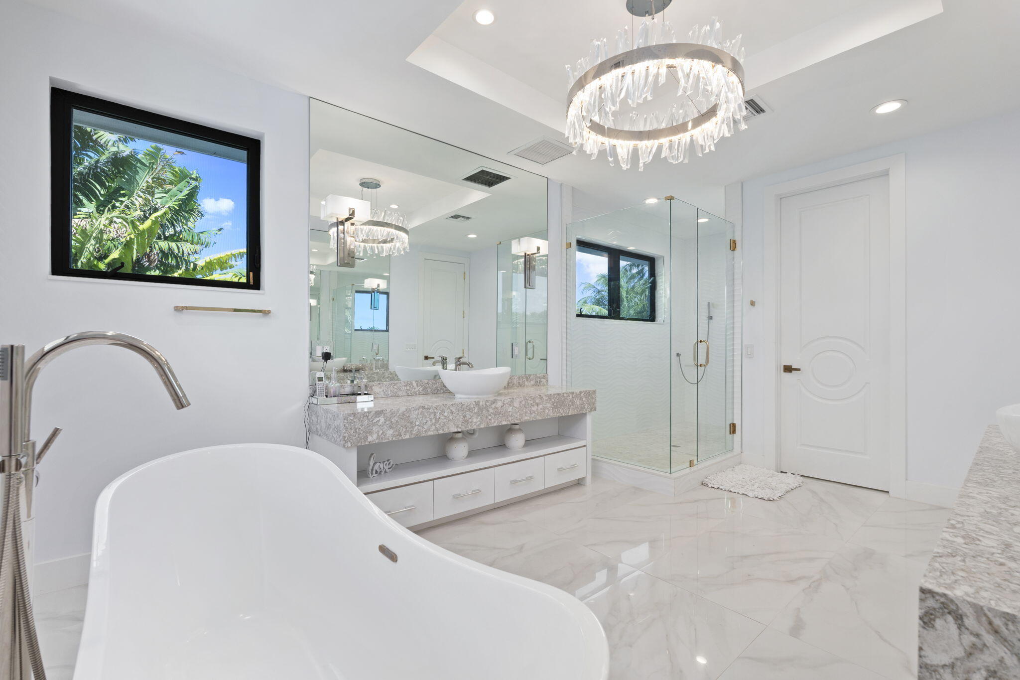 742 Marble Court Boca Raton, FL 33432 - Photo 34 of 95 a spacious bathroom with a double vanity sink a large mirror and a shower