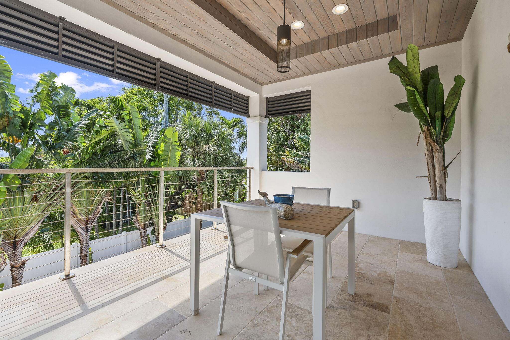742 Marble Court Boca Raton, FL 33432 - Photo 43 of 95 a view of a patio with table and chairs and a potted plant