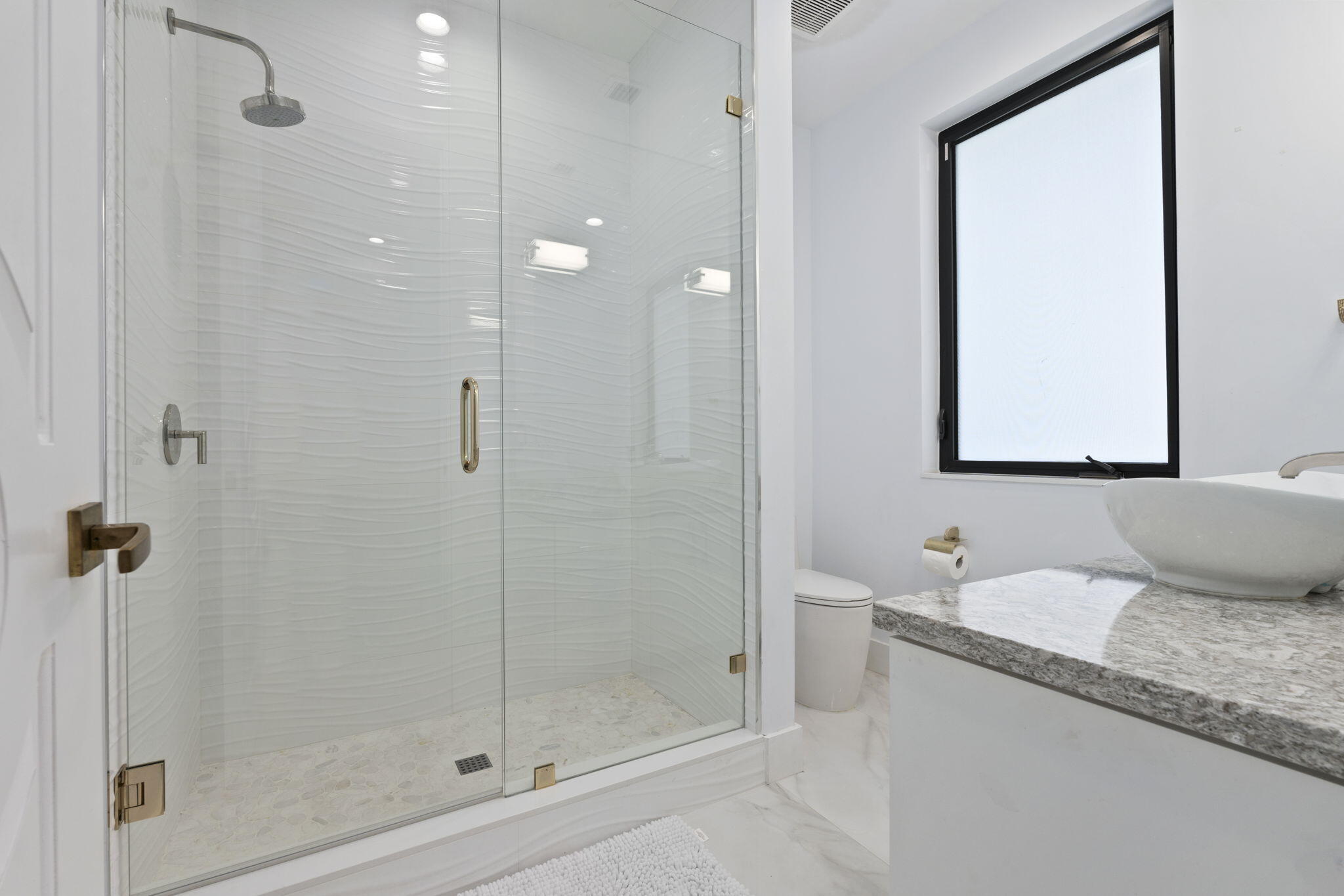 742 Marble Court Boca Raton, FL 33432 - Photo 52 of 95 a bathroom with a granite countertop sink a mirror and shower