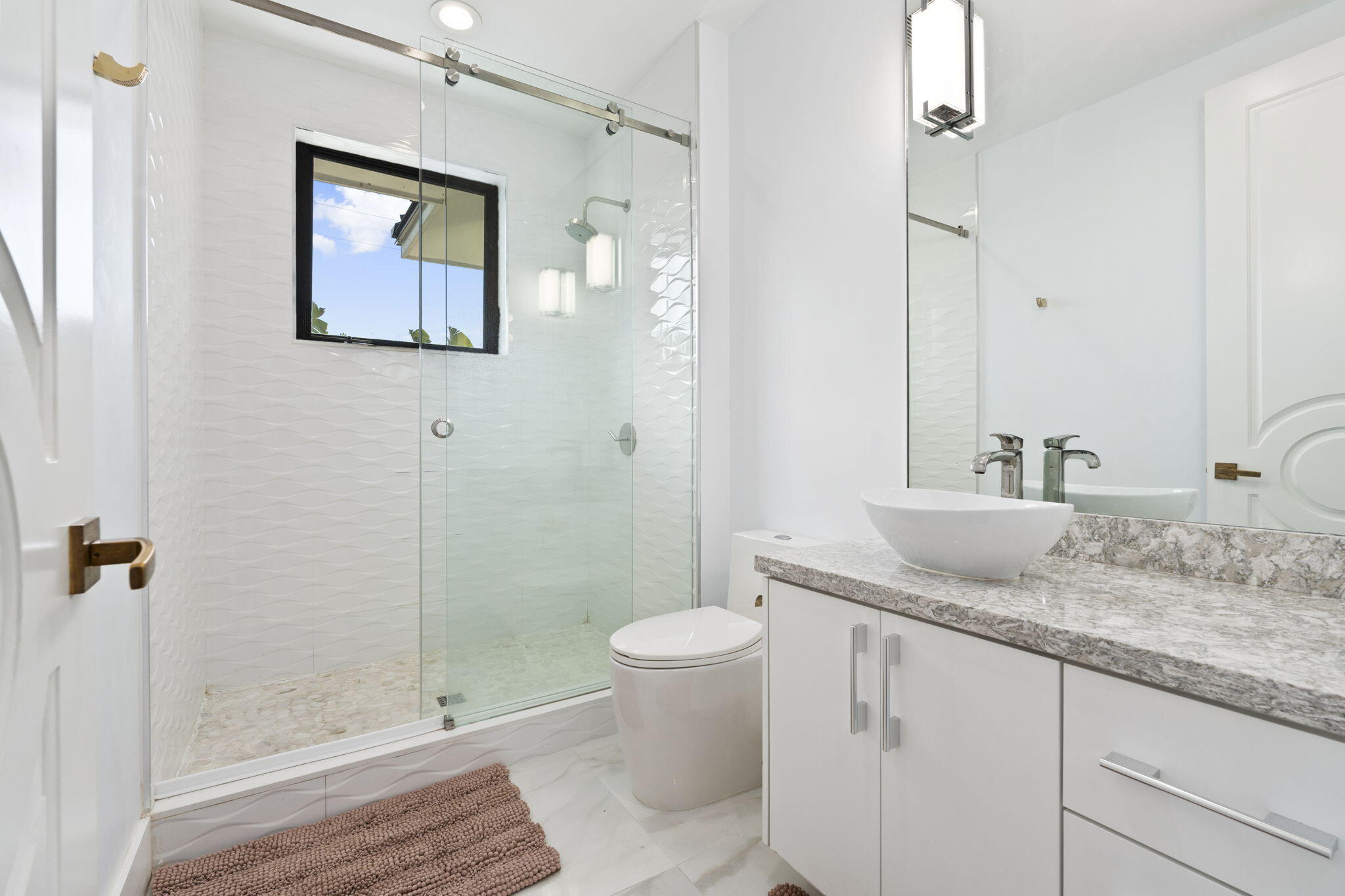 742 Marble Court Boca Raton, FL 33432 - Photo 57 of 95 a bathroom with a granite countertop sink a toilet and shower