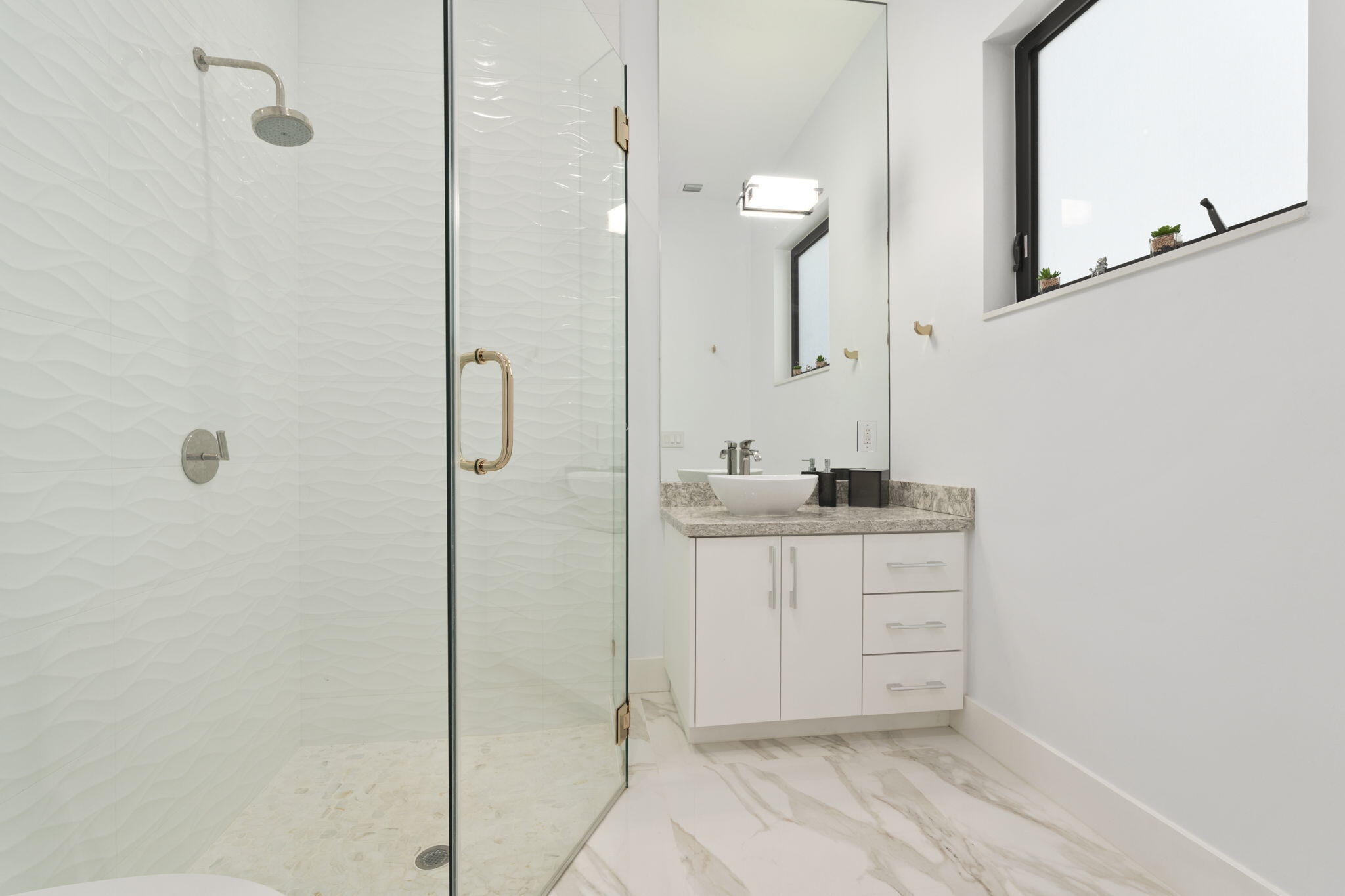 742 Marble Court Boca Raton, FL 33432 - Photo 60 of 95 a bathroom with a shower a sink and mirror