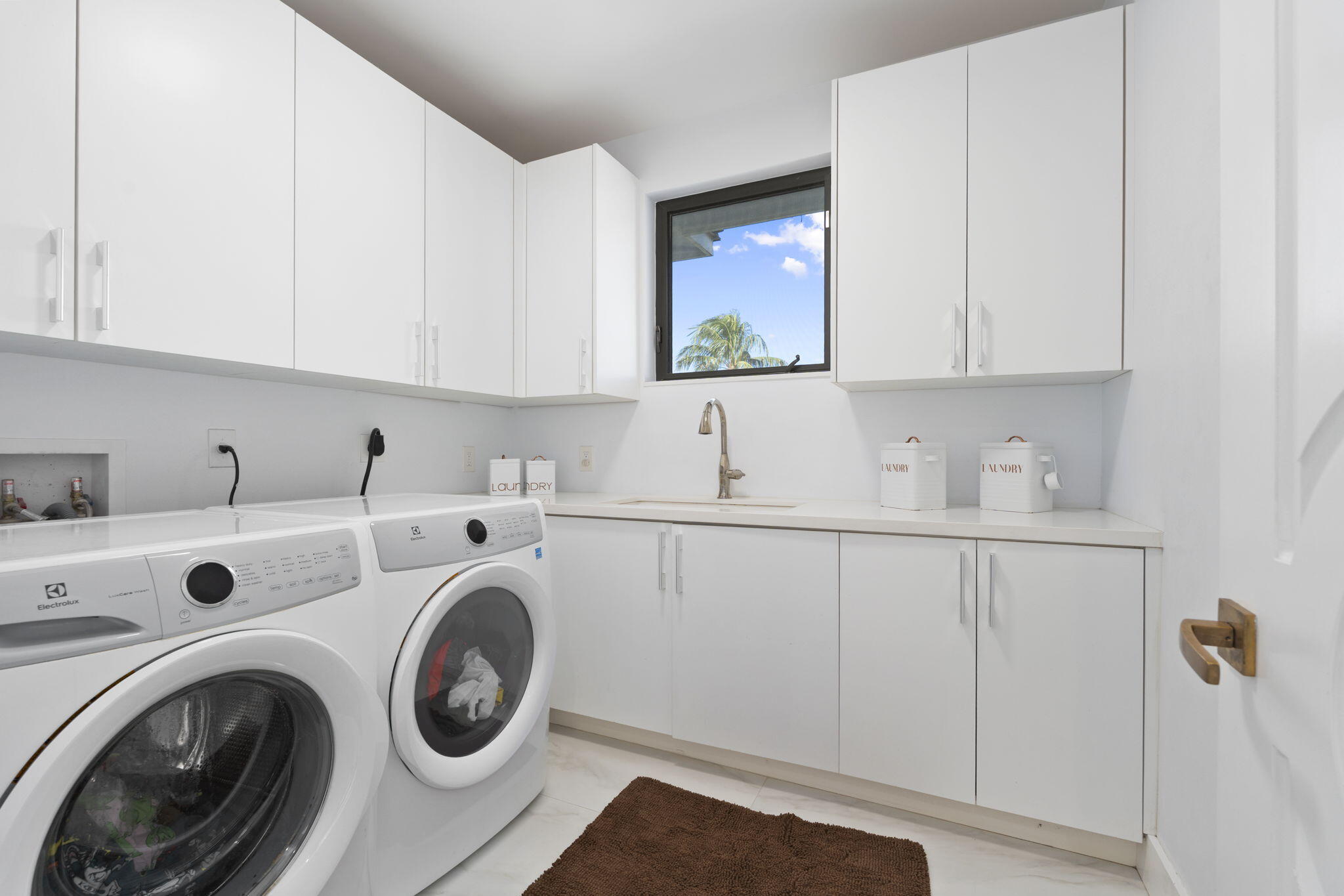 742 Marble Court Boca Raton, FL 33432 - Photo 63 of 95 a view of cabinets and washer in a kitchen
