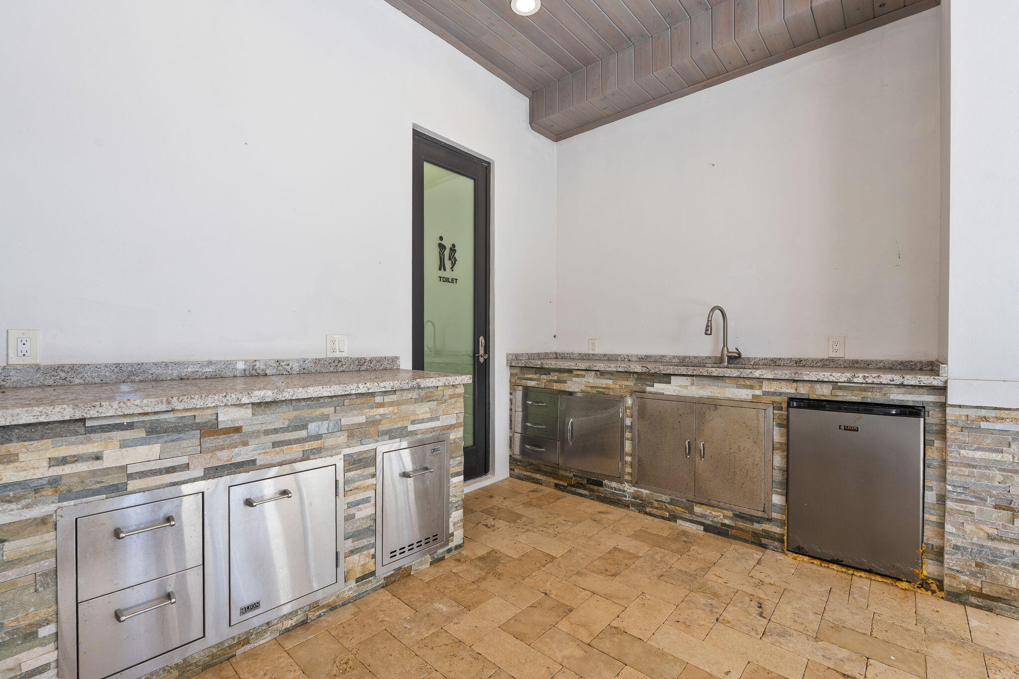 742 Marble Court Boca Raton, FL 33432 - Photo 75 of 95 a view of a kitchen with granite countertop a stove top oven microwave and a sink