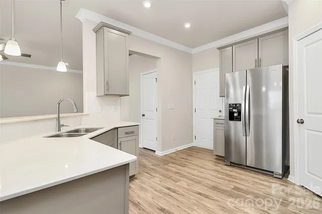 a kitchen with a refrigerator and a sink