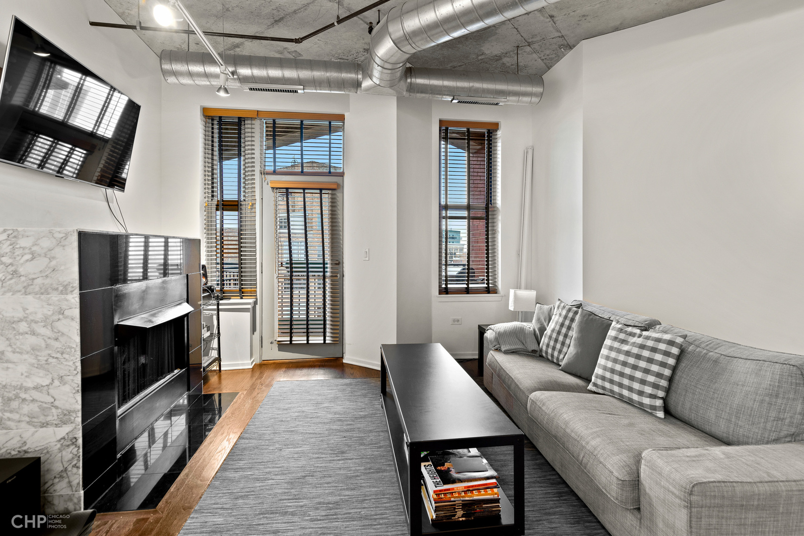 6 South Laflin Street, Unit 721 Chicago, IL 60607 - Photo 2 of 20 a living room with furniture and a fireplace
