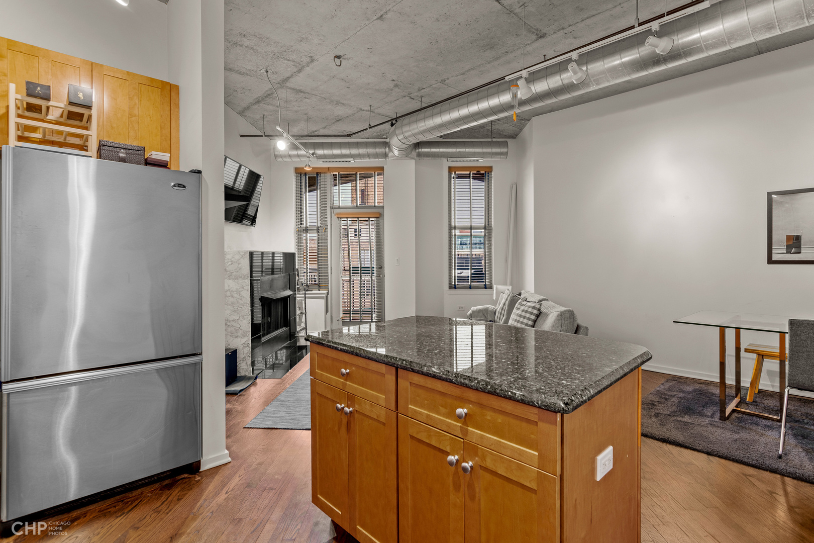 6 South Laflin Street, Unit 721 Chicago, IL 60607 - Photo 11 of 20 a kitchen with granite countertop a refrigerator and a sink