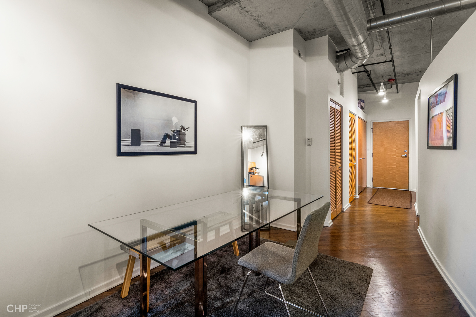 6 South Laflin Street, Unit 721 Chicago, IL 60607 - Photo 13 of 20 a view of a hallway with wooden floor and dining room