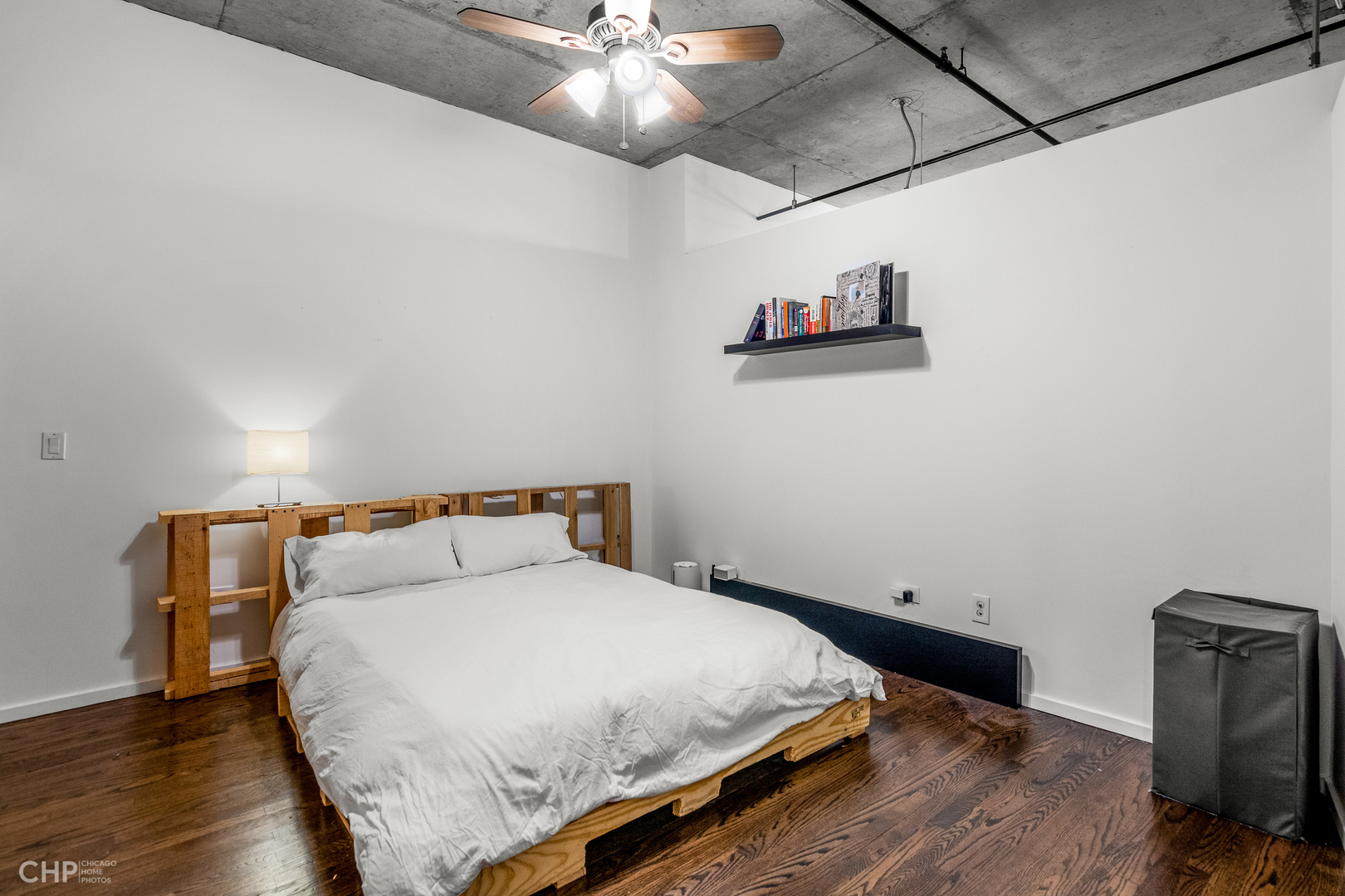6 South Laflin Street, Unit 721 Chicago, IL 60607 - Photo 14 of 20 a bedroom with a bed and wooden floor