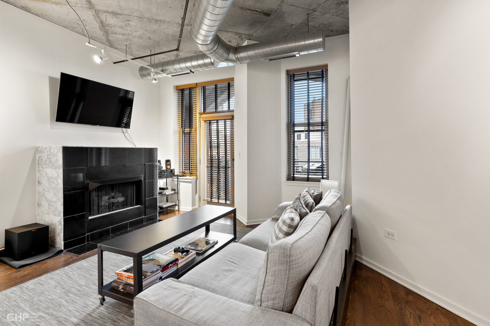 6 South Laflin Street, Unit 721 Chicago, IL 60607 - Photo 3 of 20 a living room with furniture a flat screen tv and a fireplace