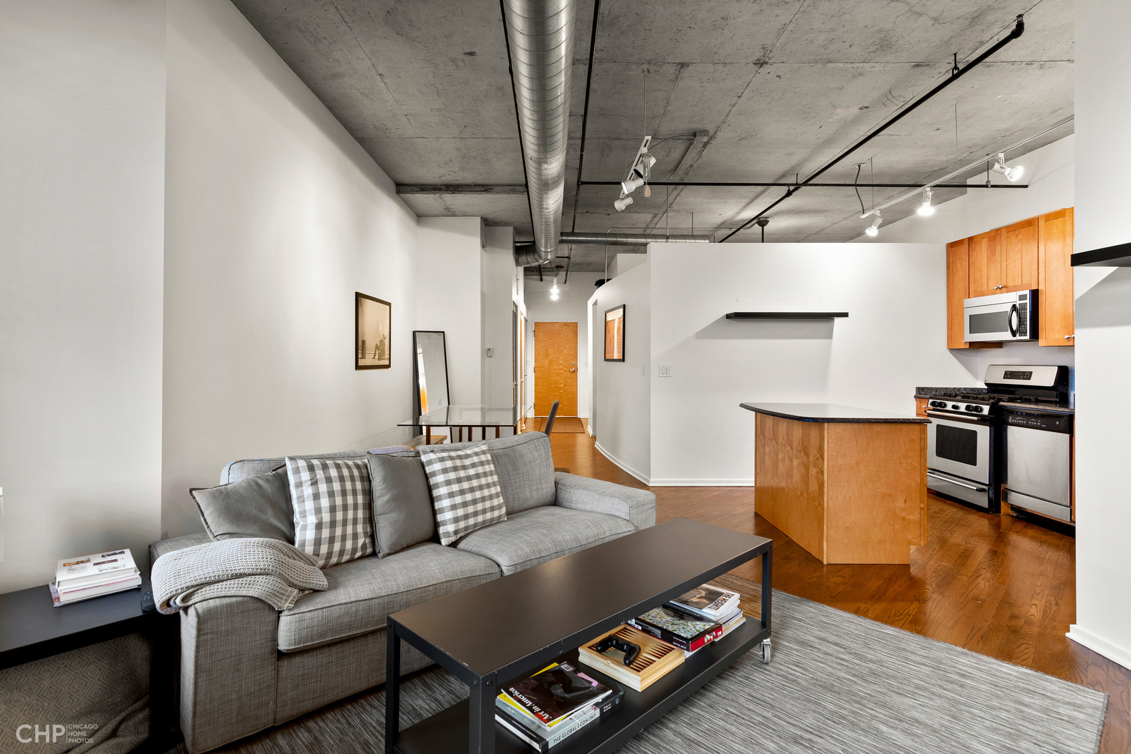 6 South Laflin Street, Unit 721 Chicago, IL 60607 - Photo 4 of 20 a living room with furniture and a wooden floor