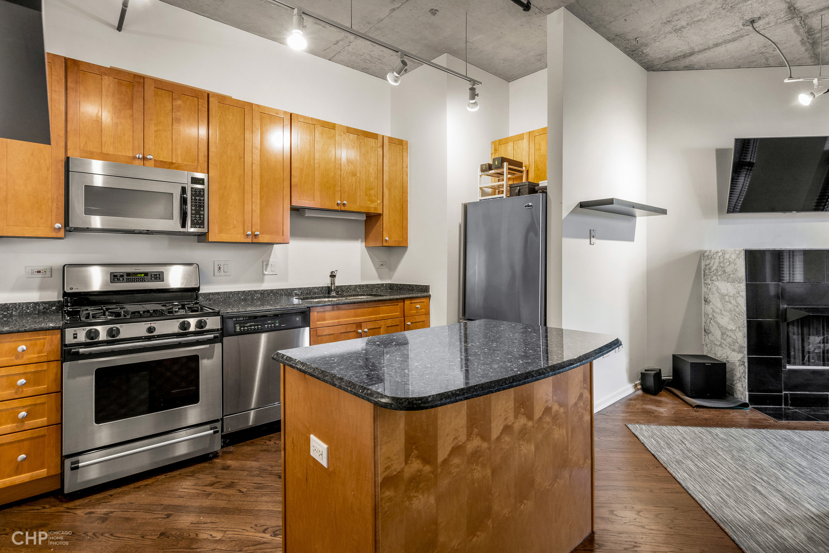6 South Laflin Street, Unit 721 Chicago, IL 60607 - Photo 7 of 20 a kitchen with stainless steel appliances granite countertop a stove a sink and a refrigerator