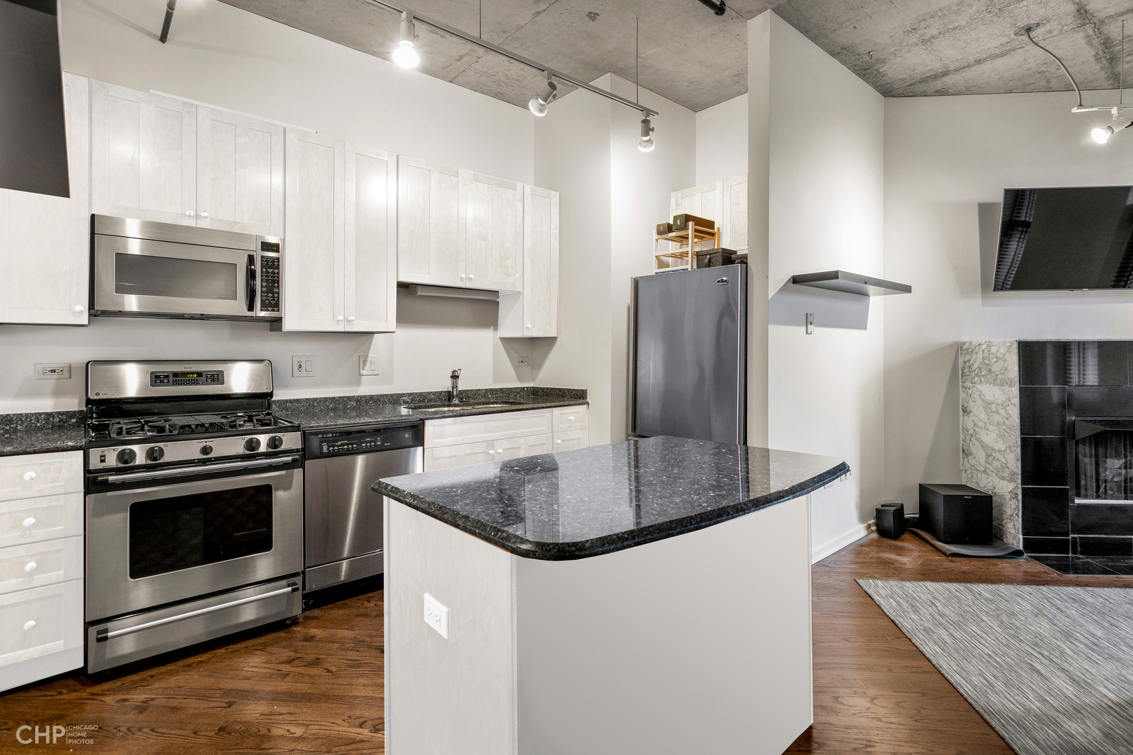 6 South Laflin Street, Unit 721 Chicago, IL 60607 - Photo 9 of 20 a kitchen with stainless steel appliances granite countertop a sink stove and refrigerator