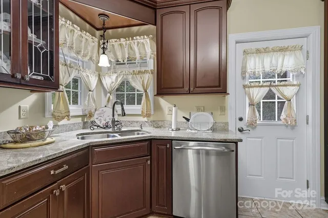 a kitchen with stainless steel appliances granite countertop a sink and cabinets