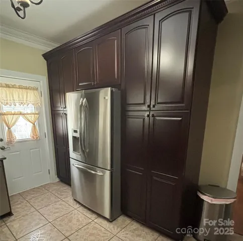 a metallic refrigerator freezer sitting in a kitchen