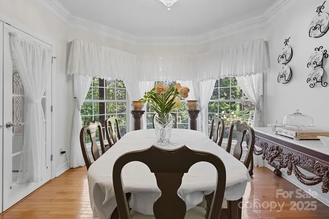 a view of a dining room with furniture and chandelier