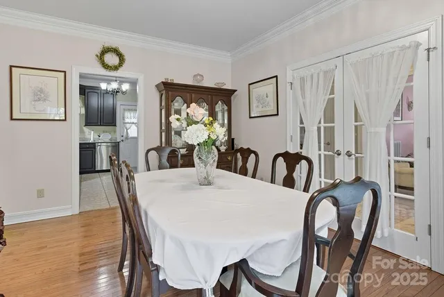 a view of a a dining room with furniture window and wooden floor