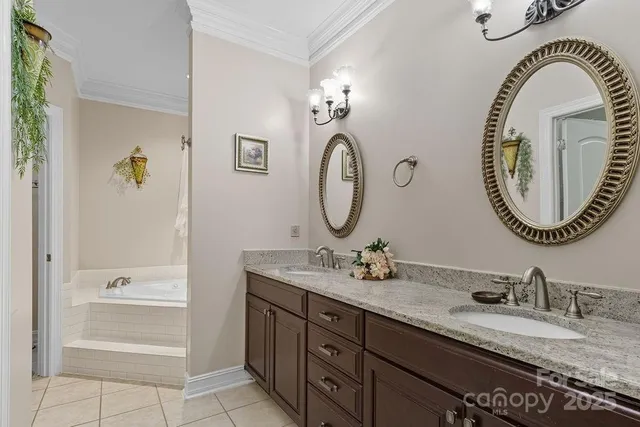 a bathroom with a granite countertop double vanity sinks and a mirror