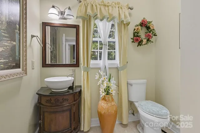 a bathroom with a toilet and a shower curtain