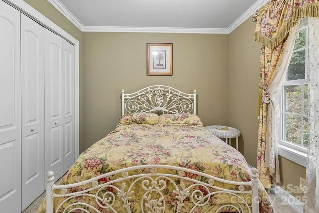 a large bed sitting in a bedroom next to a window