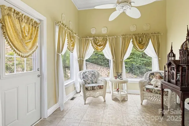 a living room with fireplace furniture and a large window