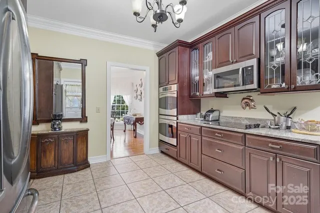 a kitchen with stainless steel appliances granite countertop a sink and cabinets