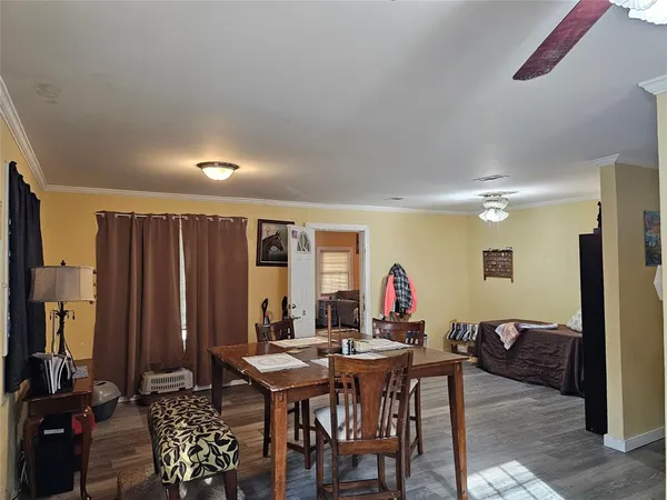 a view of a a dining room with furniture window and wooden floor