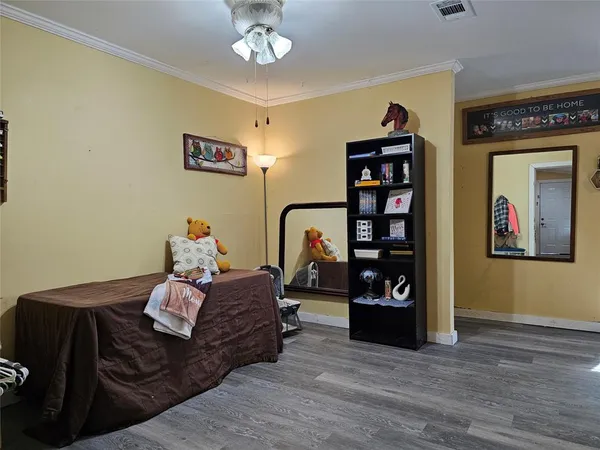 a bed room with furniture and wooden floor