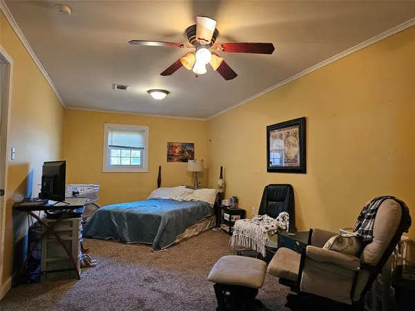 a bedroom with furniture and a window