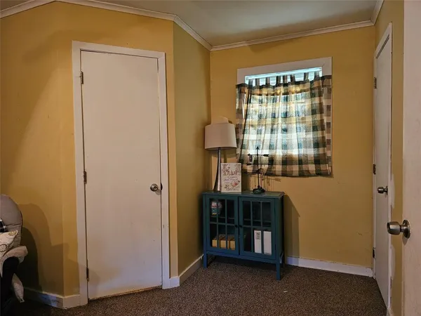 a view of a room with a door and front door