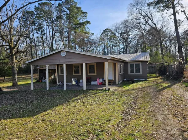 a view of a house with a yard and sitting area