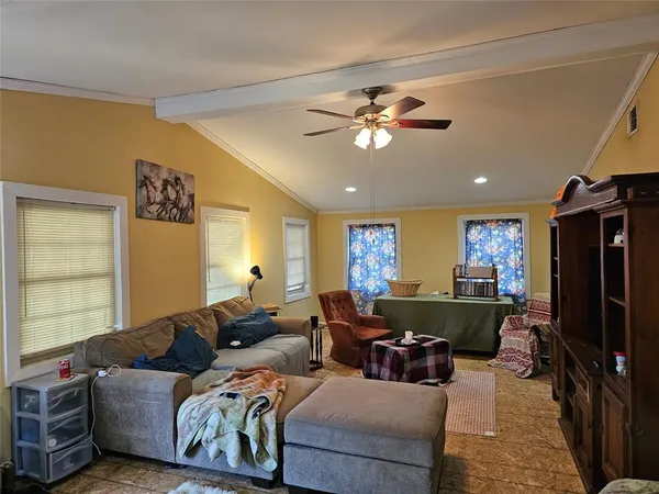 a living room with furniture a large window and a flat screen tv