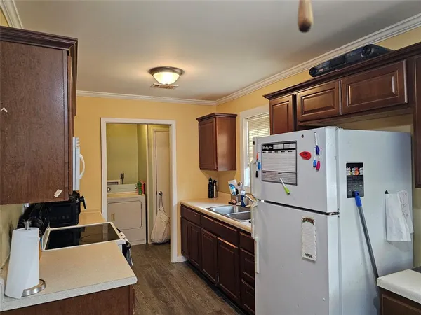 a kitchen with stainless steel appliances a refrigerator sink and cabinets