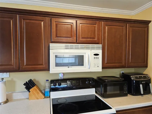 a kitchen with granite countertop cabinets and black appliances