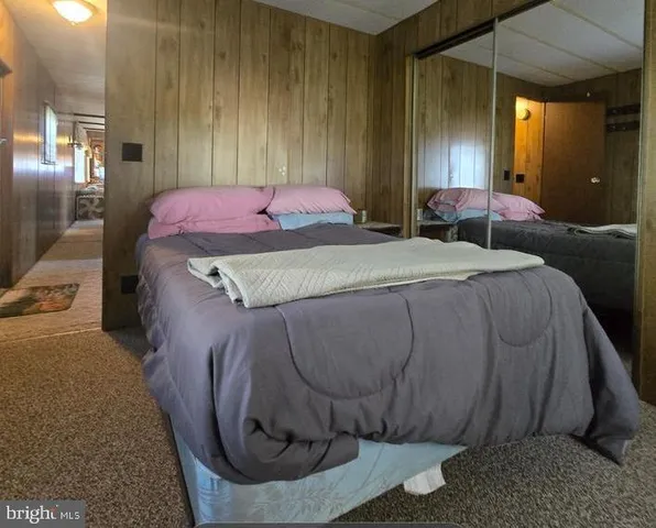 a bedroom with a bed and a mirror