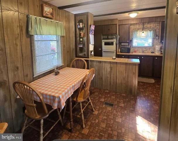 a dining room with a wooden table and chairs