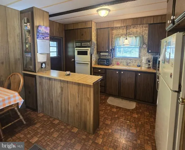 a kitchen with stainless steel appliances a refrigerator and a stove