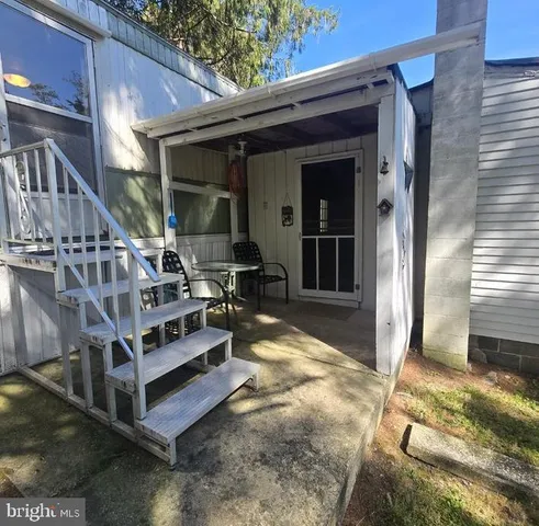 a view of a balcony with table and chairs