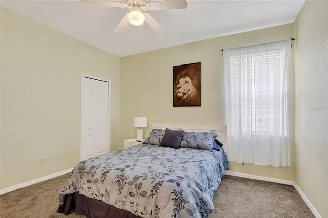 a bedroom with a bed and a painting on the wall