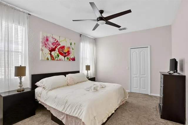 a bedroom with a bed and a painting on the wall